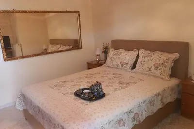 a bed with a tray of food on it with a mirror at Giannis Traditional House in Vamos