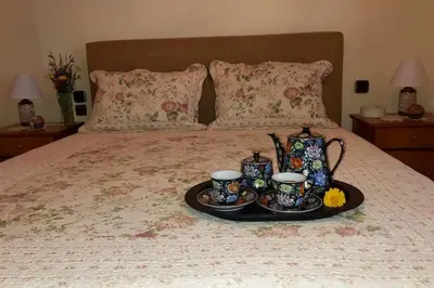 a tray of tea cups and saucers on a bed at Giannis Traditional House in Vamos