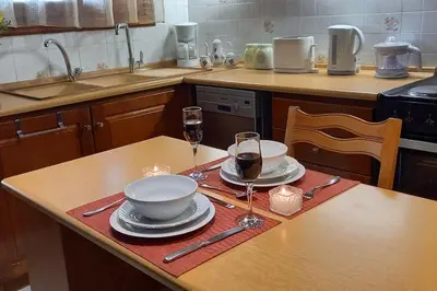 a kitchen with a table with two glasses of wine at Giannis Traditional House in Vamos