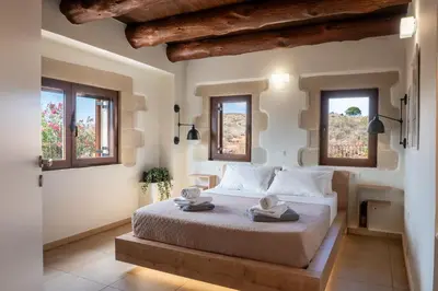 a bedroom with a bed with two towels on it at Villa Recluso-3 bd luxury country villa, huge heated pool with hydromassage, individual bbq & large yard, mountain view in Maláxa