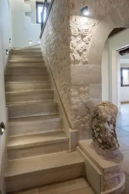 a staircase in a building with a stone wall at Villa Recluso-3 bd luxury country villa, huge heated pool with hydromassage, individual bbq & large yard, mountain view in Maláxa