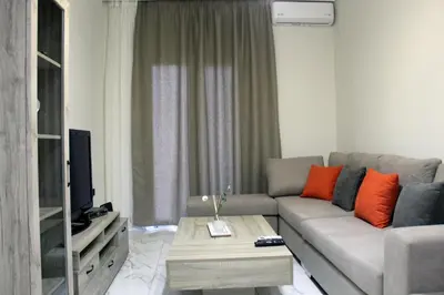 a living room with a couch and a tv at Monica's Luxury Apartment in Chania Town