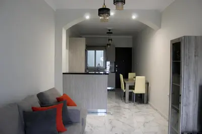 a living room with a couch and a table with chairs at Monica's Luxury Apartment in Chania Town
