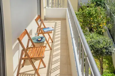 two chairs and a table on a balcony at Casa Kamara in Kounoupidhianá