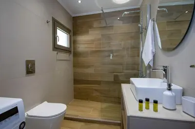 a bathroom with a sink and a toilet and a shower at Vigla Apartments No.3 in AmigdhalokeFálion