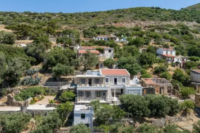 an aerial view of a large white house on a hill at Vigla Apartments No.3 in AmigdhalokeFálion