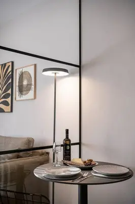 a table with a bottle of wine and a glass at Marita Luxury Apartment with parking space in Chania Town