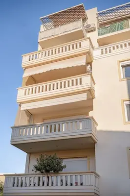 a building with a plant on the side of it at Marita Luxury Apartment with parking space in Chania Town