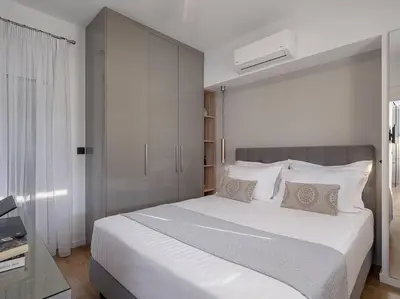 a bedroom with a large white bed with white pillows at Marita Luxury Apartment with parking space in Chania Town