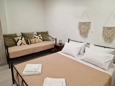 a living room with two beds and a couch at Granny's Nest in Kalyves