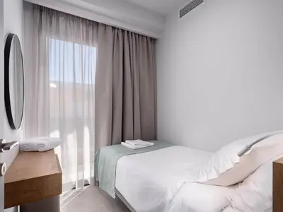 a bedroom with a bed and a large window at Casa D'Irene Apts in Chania Town