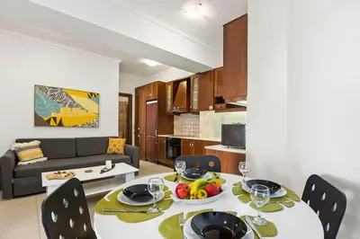 a living room with a table and a couch at Private apartment in Kalamaki, Chania in Galatás