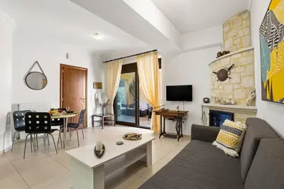 a living room with a couch and a table at Private apartment in Kalamaki, Chania in Galatás