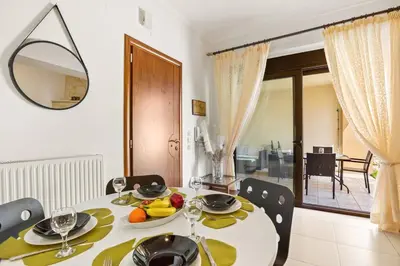 a dining room with a table with a bowl of fruit on it at Private apartment in Kalamaki, Chania in Galatás
