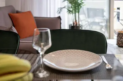a table with a plate and a wine glass at Angelo Luxury Apartment in Chania Town