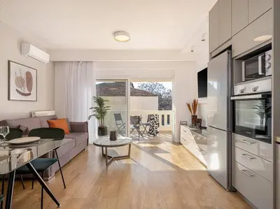a living room with a couch and a table and a kitchen at Angelo Luxury Apartment in Chania Town