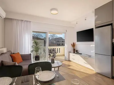 a living room with a couch and a kitchen at Angelo Luxury Apartment in Chania Town