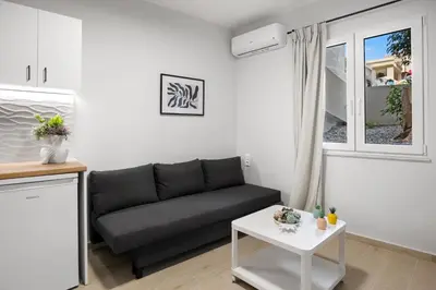 a living room with a couch and a table at Nisos apartments, Chania center in Chania Town