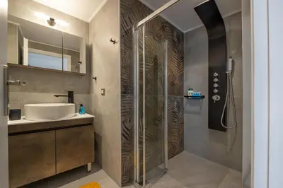 a bathroom with a shower and a sink at -Superior Maisonette Jacuzzi & Private Parking - Koum Kapi Mare Seaside in Chania Town