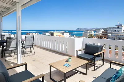 a balcony with chairs and tables and a view of the ocean at -Superior Maisonette Jacuzzi & Private Parking - Koum Kapi Mare Seaside in Chania Town