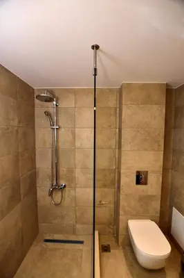 a bathroom with a shower with a toilet and a sink at Rosemary Apartments in Palaiochóra