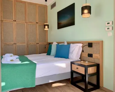 a bedroom with a large bed with a table at Christos Place-Paleochora in Palaiochóra