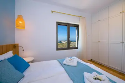 a bedroom with a bed with towels on it at Christos Place-Paleochora in Palaiochóra