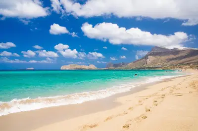 a beach with the ocean and mountains in the background at Christine luxury villa in Kolymvari