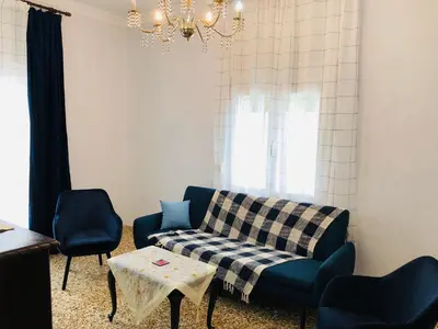 a living room with a couch and two chairs at Stamatias Home, fully equipped cottage 5 minutes from the sea in Chania Town