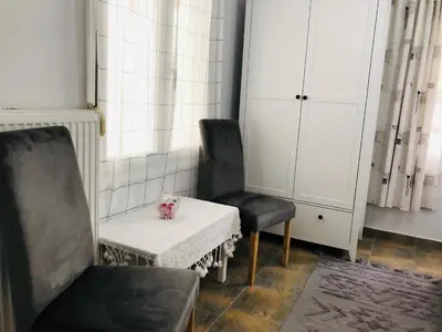 two chairs and a table with a vase on it at Stamatias Home, fully equipped cottage 5 minutes from the sea in Chania Town