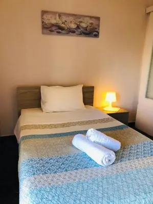 a bedroom with a bed with two towels on it at Ariadni's apartment 2 in Chania Town
