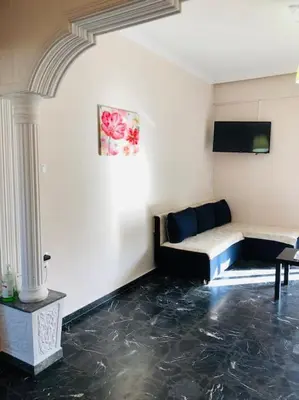 a living room with a couch and a table at Ariadni's apartment 2 in Chania Town