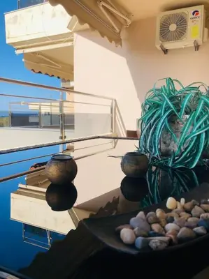 a table with a plate of rocks and a bowl of water at Ariadni's apartment 1 in Chania Town