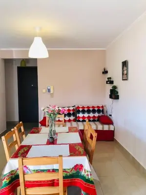 a dining room with a table and chairs and a bed at Ariadni's apartment 1 in Chania Town