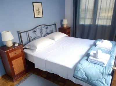 a bedroom with a large white bed and a night stand at Capt73134 in Chania Town