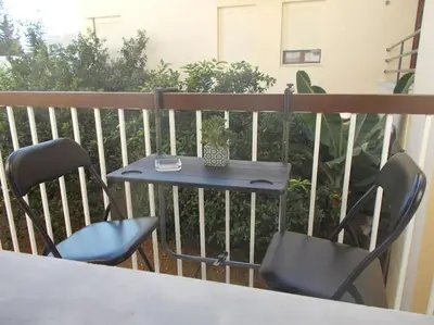 a table and two chairs on a balcony at Capt73134 in Chania Town