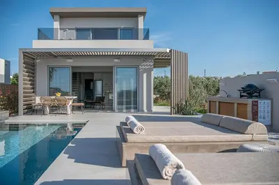 a villa with a swimming pool and a house at Fivi Villa, with Heated Pool & SeaViews, By ThinkVilla in Tavronitis