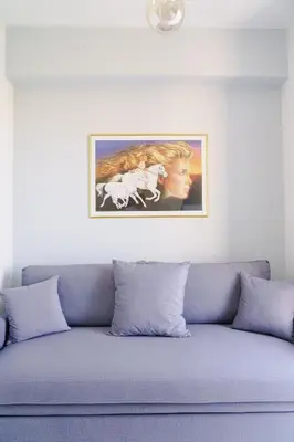 a couch with a picture on the wall above it at EDEL Luxury Apartments in Chania Town