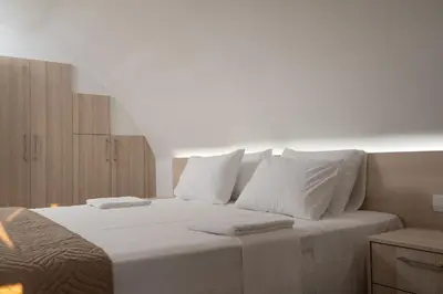 a bedroom with a large white bed with white pillows at EDEL Luxury Apartments in Chania Town