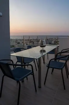 a table and chairs on a balcony with a view at EDEL Luxury Apartments in Chania Town