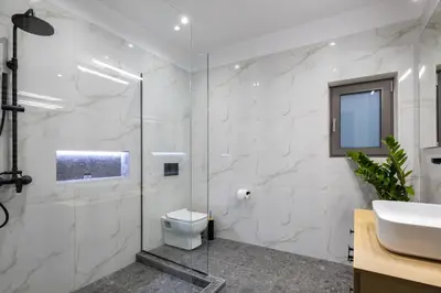 a white bathroom with a toilet and a sink at Casa Dionysia - New Lux 2Br with Jacuzzi near Maleme Beach in Maleme