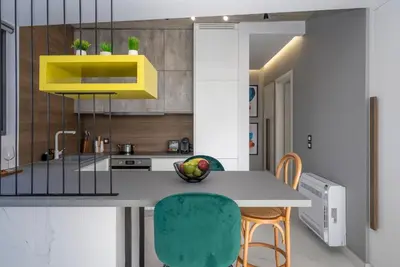 a kitchen with a table and chairs in a room at Disegno Residences in Chania Town