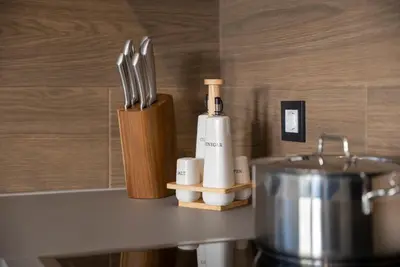 a kitchen counter with a knife block and a blender at Disegno Residences in Chania Town