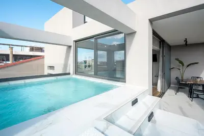 a swimming pool in the middle of a house at Disegno Residences in Chania Town