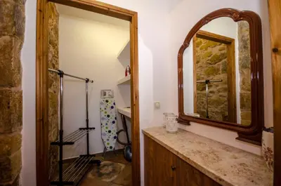 a bathroom with a mirror and a sink at Metochi Traditional House in Chania Town