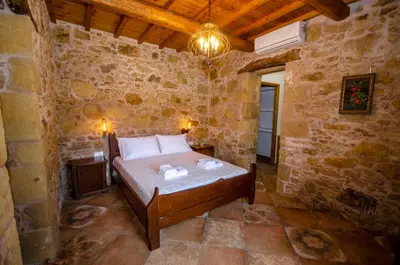a bedroom with a bed in a stone room at Metochi Traditional House in Chania Town