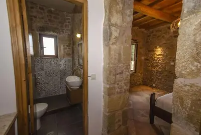a bathroom with a toilet and a sink in a room at Metochi Traditional House in Chania Town
