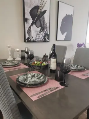 a table with glasses of wine and a hat on it at Dimitras residence in Chania Town