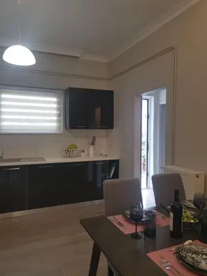 a living room with a table and a kitchen at Dimitras residence in Chania Town