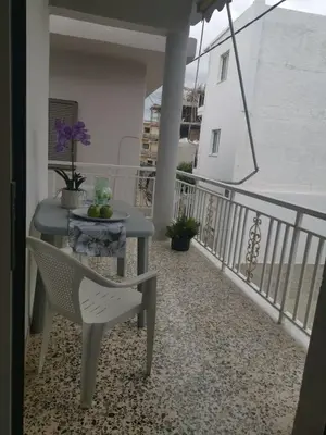 a table and a chair on a balcony at Dimitras residence in Chania Town